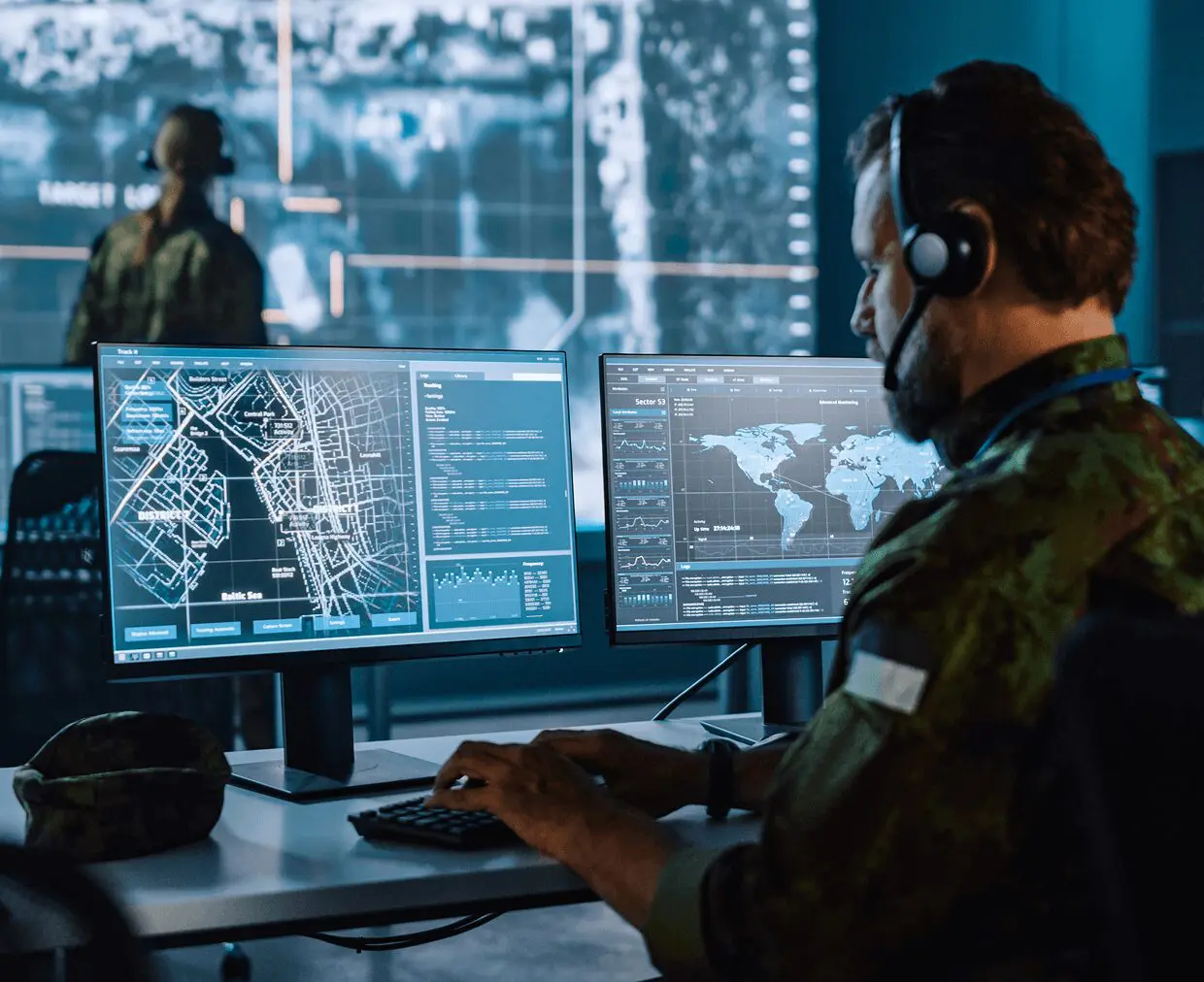 GettyImages-1355657756 (1) (1) Military officer analyzing data on computer screens.